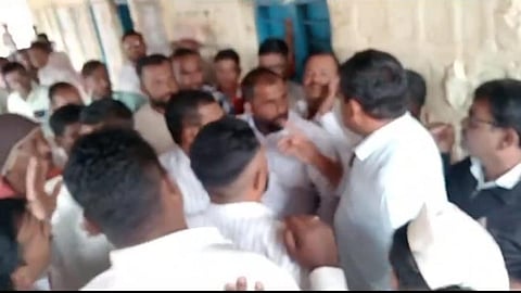 SDMC members of both Kannada and Marathi medium schools argue over allocation of space to build classrooms for Kannada students, in Karadaga village on Friday | Express