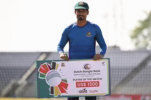 Bangladesh’s Taijul Islam poses for a photo with the man of the match prize after Bangladesh won the first Test cricket match between Bangladesh and New Zealand on December 2, 2023. (Photo | AFP)