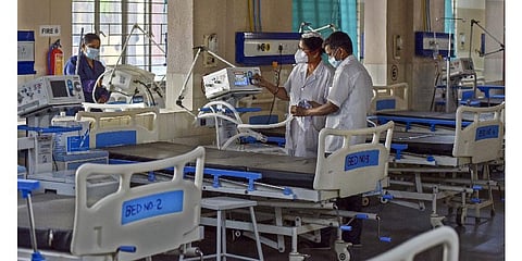 Healthcare workers arrange medical equipments and beds at the Government Fever Hospital after the Centre issued COVID advisory measures, in Hyderabad. (Photo | PTI)