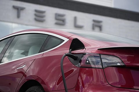 FILE - A 2021 Model 3 sedan charges at a Tesla dealership in Littleton, Colo., on June 27, 2021. (Photo | AP)