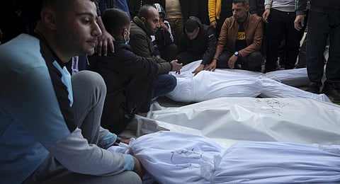 Palestinians mourn their relatives killed in the Israeli bombardment of the Gaza Strip in Deir al Balah on Wednesday, Dec. 20, 2023. (AP Photo)