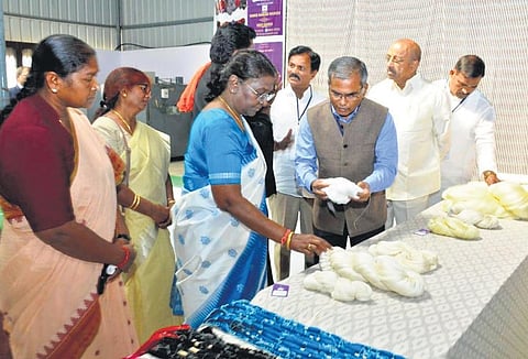 President Droupadi Murmu inspects yarn at a spinning unit in Bhoodan Pochampally town in Yadadri Bhuvanagiri district on Wednesday