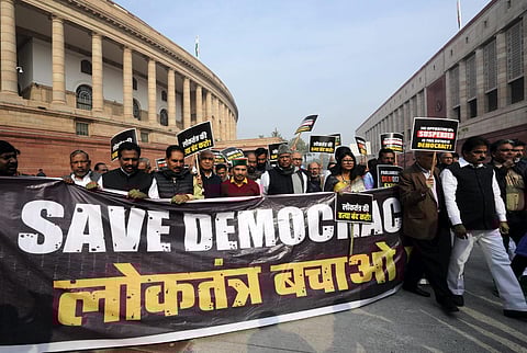 Leader of Opposition in the Rajya Sabha Mallikarjun Kharge with suspended opposition MPs during a protest over their suspension at Mahatma Gandhi statue | PTI