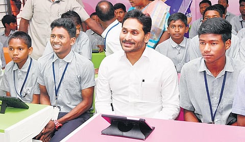 Chief Minister YS Jagan Mohan Reddy with government school students at Chinturu in Alluri Sitarama Raju district on Thursday | Express