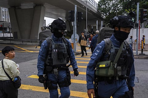 Police officers from the counter terrorism unit patrol outside the West Kowloon Magistrates' Courts, where activist publisher Jimmy Lai's trial takes place, in Hong Kong, Tuesday, Dec. 19, 2023.