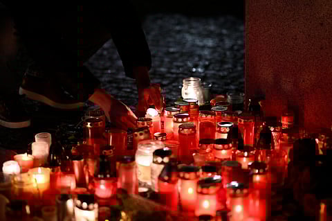 People lay candles light outside the building of Philosophical Faculty of Charles University for victims of mass shooting in Prague, Czech Republic on Friday, December 22, 2023. (Photo | AP)