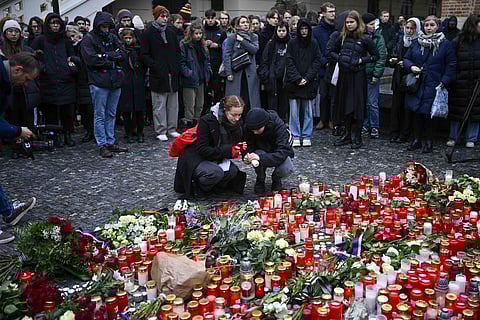 Mourners lay candle lights outside the headquarters of Charles University for victims of mass shooting in Prague, Czech Republic. (Photo | AP)