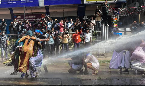 Police use water cannon to disperse KSU activists during their protest march to the Police Headquarters. (Photo | PTI)