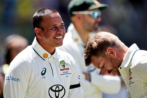 Australia’s David Warner (R) and Usman Khawaja leave at the lunch break during the first day of the first Test cricket match between Australia and Pakistan on December 14, 2023. (File photo | AFP)