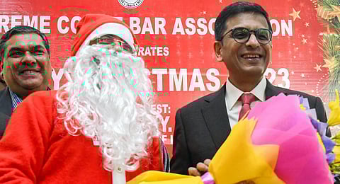 Chief Justice of India (CJI) Justice DY Chandrachud being felicitated with a bouquet during the Christmas Day programme, at the Supreme Court of India (SCI), in New Delhi on Monday. (Photo | ANI)