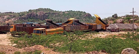 Dump trucks parked near the under-construction Shivannagudem Reservoir. (EPS Photo)