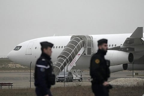 Gendarmes patrol by the plane grounded by police based that it could be carrying trafficking victims, at the Vary airport , Monday, Dec. 25, 2023 in Vatry, eastern France.(Photo | PTI)