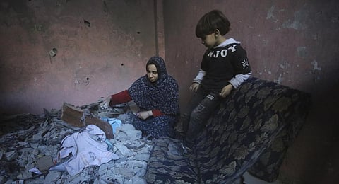 Palestinians salvage their belongings after an Israeli strike in Rafah, Gaza Strip. (Photo | AP)
