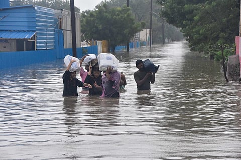 Public wading through a flooded street in Thoothukudi. (File Photo | V Karthik Alagu, EPS)