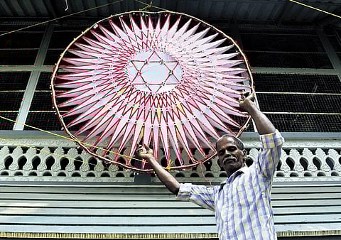 Antony C J along with the handmade star hanged in front of his house in Mundumvelli. (Photo | A Sanesh)