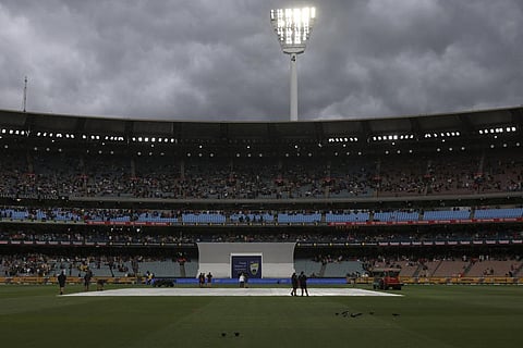 Covers are placed on the wicket as weather interrupts play between Australia and Pakistan during their cricket test match in Melbourne, Tuesday, Dec. 26, 2023. (Photo | AP)