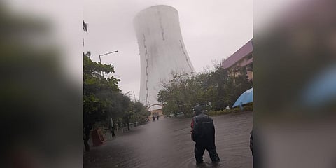 A worker wades through a waterlogged road near the Thoothukudi Thermal Power Station | Express