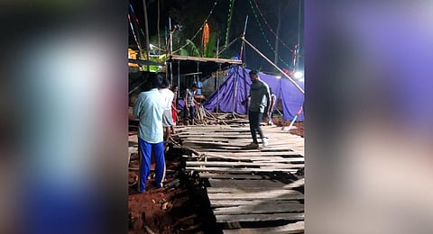 Locals at the site after a makeshift bridge at Neyyattinkara collapsed, in Thiruvananthapuram district, Monday, Dec. 25, 2023. | PTI