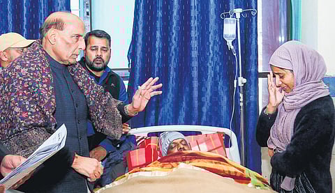 Rajnath Singh interacting with an injured person’s family in J&K on Wednesday | PTI