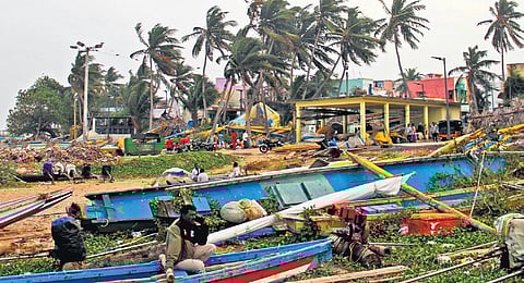 As the tides turn turbulent under the influence of the storm, fishermen moor their boats to the shore in Visakhapatnam on Saturday I G Satyanarayana
