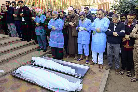 Mourners recite a prayer over the bodies of victims killed Israeli bombing in Khan Yunis in the southern Gaza Strip on December 3, 2023. (Photo | AFP)