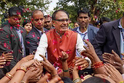 Madhya Pradesh Chief Minister Shivraj Singh Chouhan with BJP workers and supporters celebrating the party's lead during the counting of votes (Photo | PTI)