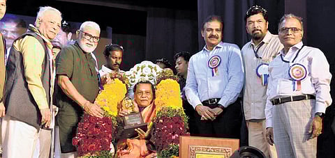 Minister Ambati Rambabu and APSFTVDC chief Posani Krishna Murali felicitating a theatre artiste on the last day of Nandi Natakotsavam in Guntur on Friday | Express
