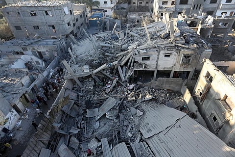 Palestinians inspect the damage following Israeli strikes on the Zawayda area of the central Gaza Strip on December 30, 2023, amid ongoing battles between Israel and the Hamas movement. (Photo | AFP)