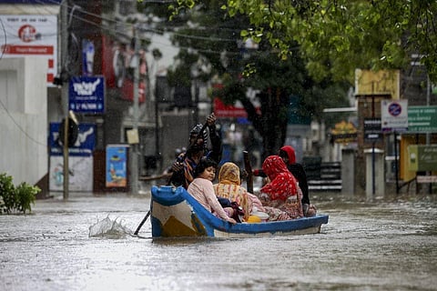 Chennai: Residents shift to a safer place from a flooded area during heavy rain owing to Cyclone Michaung, in Chennai, Monday, Dec. 4, 2023. (Photo l PTI)