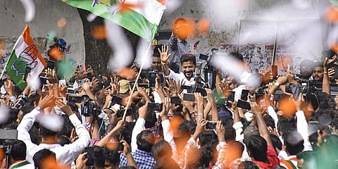 Congress Telangana President A Revanth Reddy greets party workers and supporters celebrating the party's lead during counting of votes for Telangana Assembly elections, in Hyderabad.,(Photo | PTI)