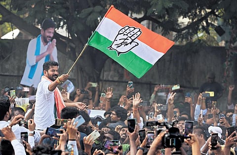 TPCC chief A Revanth Reddy waves the party flag at Gandhi Bhavan amidst a huge number of supporters in Hyderabad following the Telangana Assembly election results | Sri Loganathan Velmurugan