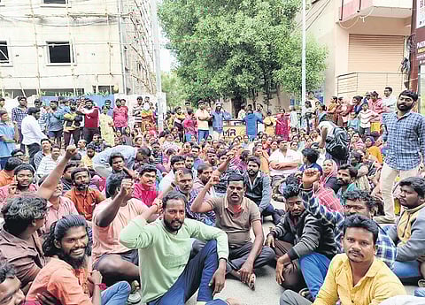 A large number of hut dwellers stage a protest in front of a double-bedroom housing block in Balasamudram under the Greater Warangal Municipal Corporation (GWMC) limits on Monday.