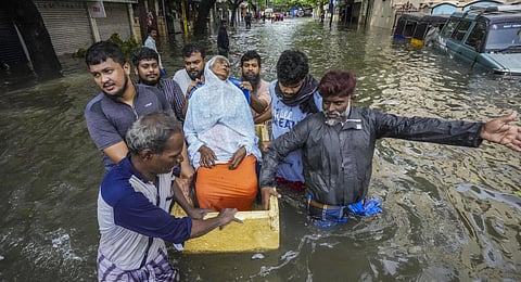 People help an elderly woman shift to a safer place from a flooded area after heavy rainfall owing to Cyclone Michaung, in Chennai, Tuesday, Dec. 5, 2023. (PTI Photo)