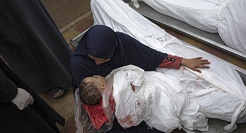 A woman mourns the bodies of her child and her husband killed in an Israeli army bombardment of the Gaza Strip, in the hospital in Khan Younis, Tuesday Dec. 5, 2023. (Photo | AP)