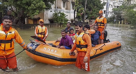 NDRF personnel evacuate residents from a waterlogged area after heavy rainfall owing to Cyclone Michaung.( Photo | PTI)