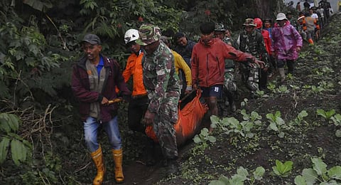 Rescuers carry the body of a victim of the eruption of Mount Marapi in Batu Palano, West Sumatra, Indonesia. (Photo | AP)