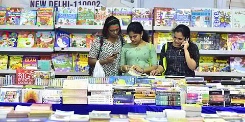 Readers are glancing through books offered at the International Book Festival being held at Durbar Hall in Kochi on Tuesday. (Photo | A Sanesh, EPS)