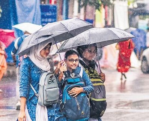 Students walk during rain in Bhubaneswar on Wednesday | DEBADATTA MALLICK