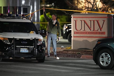 A police officer walks under crime scene tape in the aftermath of a shooting at the University of Nevada, Las Vegas, Wednesday, Dec. 6, 2023, in Las Vegas. (AP)