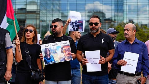 Lebanese journalists hold a portrait of Reuters videographer Issam Abdallah and Al Jazeera journalist Shireen Abu Akleh (both killed in the war) during a protest in front of the UN HQ in Beirut | AP