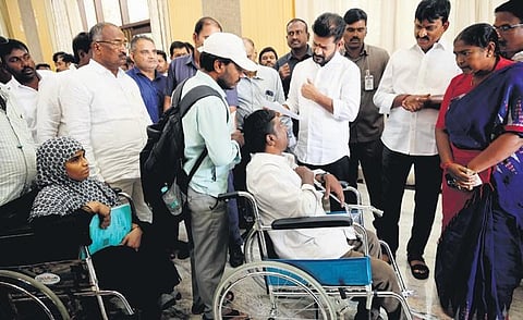 Chief Minister A Revanth Reddy, along with Ministers Ponguleti Srinivasa Reddy and Seethakka, hear an attendee at the Praja Darbar in Hyderabad on Friday