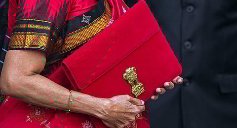 Union Finance Minister Nirmala Sitharaman carrying a folder-case poses for photographs outside the Finance Ministry. (Photo | PTI)
