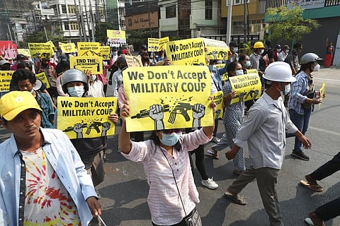 Anti-coup protesters display signs during a protest against the military coup in Mandalay, Myanmar. (Photo | AP)