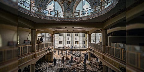 Plain-clothed policemen gather over the rubble of a damaged mosque following January's 30 suicide blast inside the police headquarters in Peshawar on February 1, 2023. (Photo | AFP)