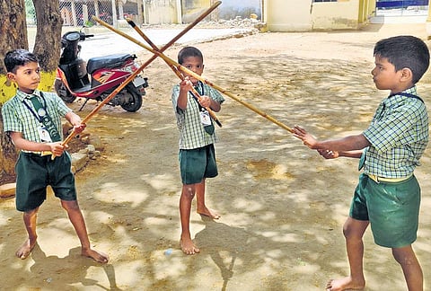 Kids at the primary school with Silambam sticks as part of their school curriculum in Virudhunagar | Express