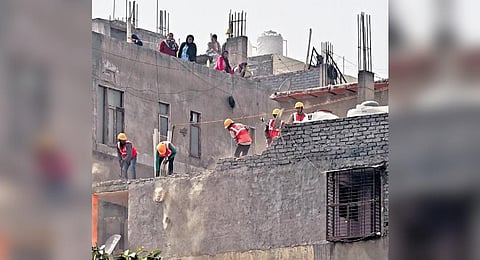 DDA workers demolish a building during an anti-encroachment drive at Mehrauli