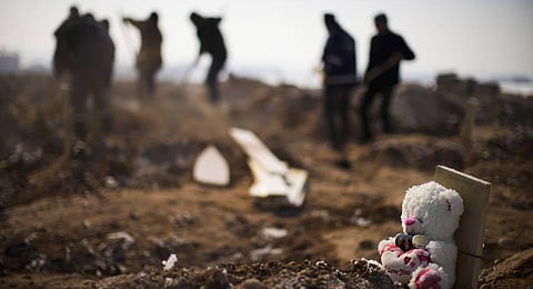 Municipal grave diggers bury the bodies of four people, three of the them not claimed by relatives, in a makeshift cemetery on the outskirts of Elbistan, Turkey. (Photo | AP)