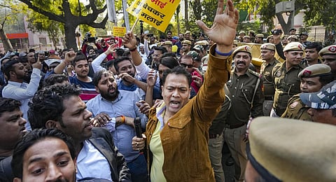 AAP workers raise slogans during their protest over Adani row, near AAP headquarters in New Delhi. (Photo | PTI)