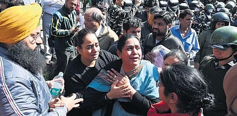 People gather at the demolition site during an anti-encroachment drive by Delhi Development Authority at Mehrauli in New Delhi on Monday. (Photo | Shekhar yadav)