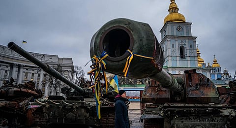 man looks at destroyed Russian military equipment in Mykhailivs'ka Square in downtown Kyiv. (Photo | AFP)